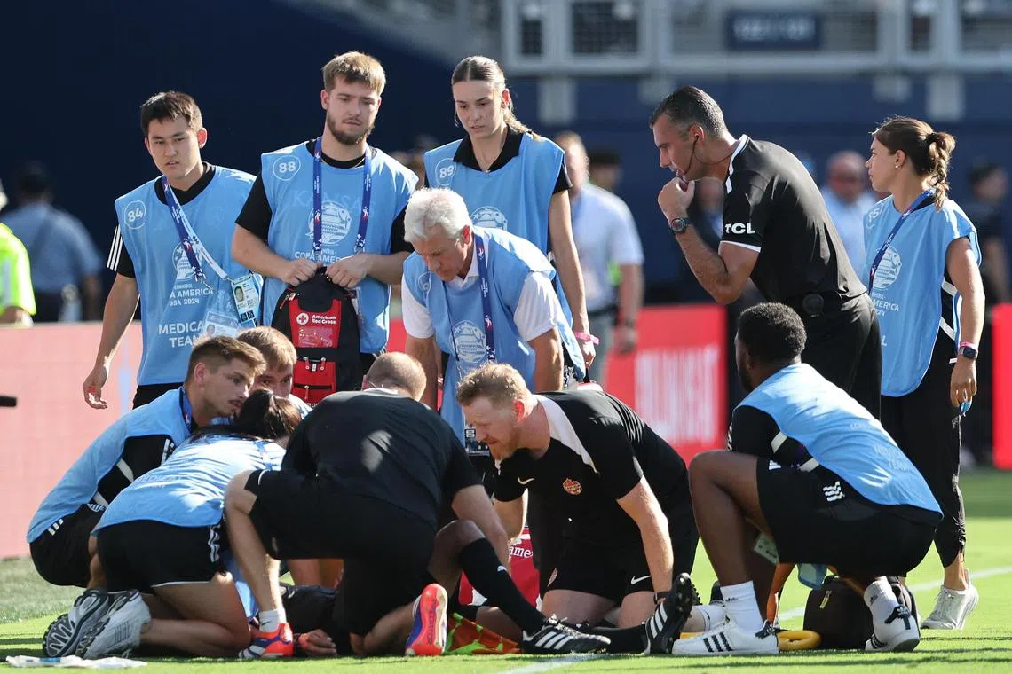 Guatemalan assistant referee Humberto Panjoj being treated by medical teams after collapsing in first-half added time in the Copa America group A match between Peru and Canada, in Kansas City on June 25, 2024. Temperatures reached 35 deg C with a real feel of 40 deg C at game time.