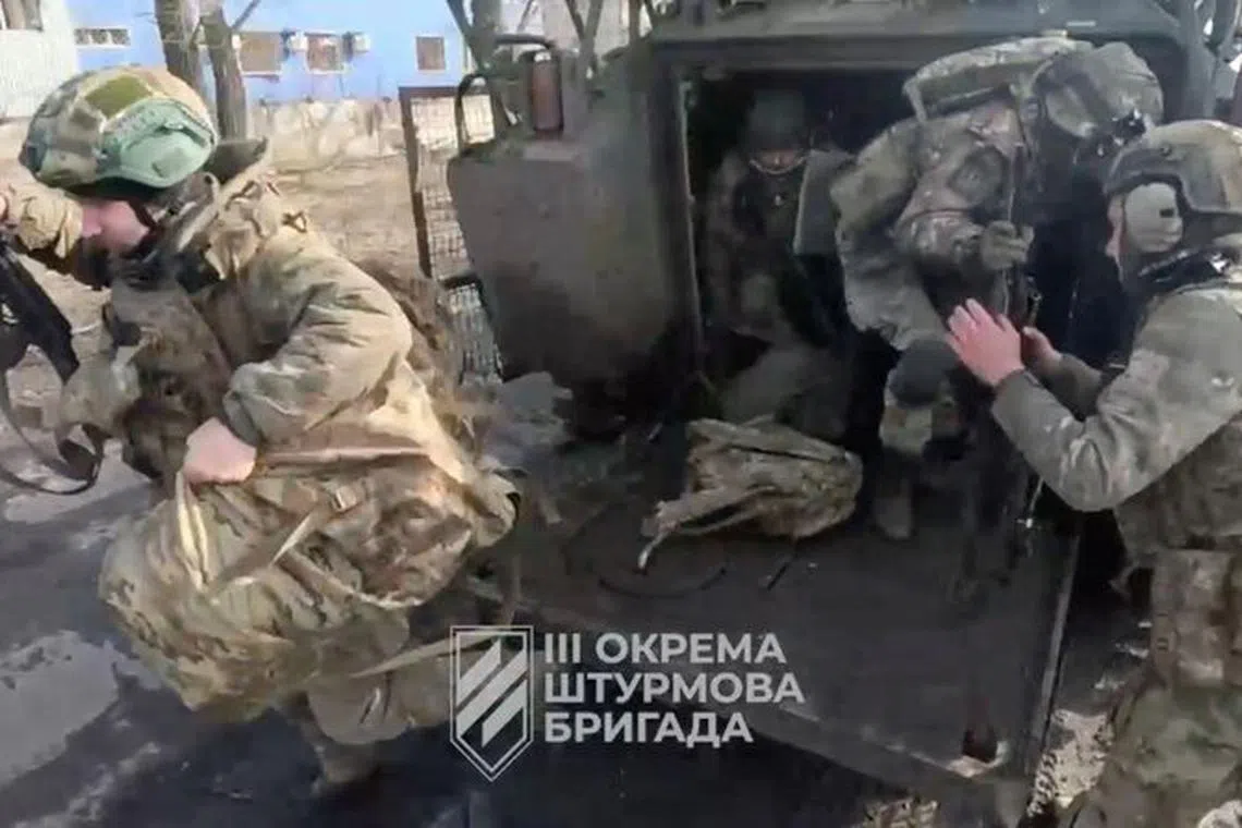 Ukrainian soldiers get out of a military vehicle in a location given as Avdiivka, Donetsk Region, Ukraine, in this screen grab taken from a video released February 17, 2024. 3Rd Assault Brigade/Handout via REUTERS