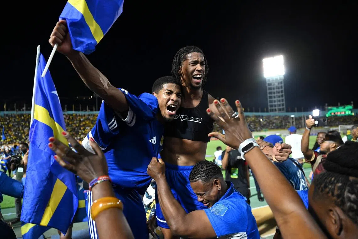 Curacao players and fans celebrating World Cup 2026 qualification after a 0-0 draw with Jamaica at the National Stadium in Kingston, Jamaica on Nov 18, 2025. 
