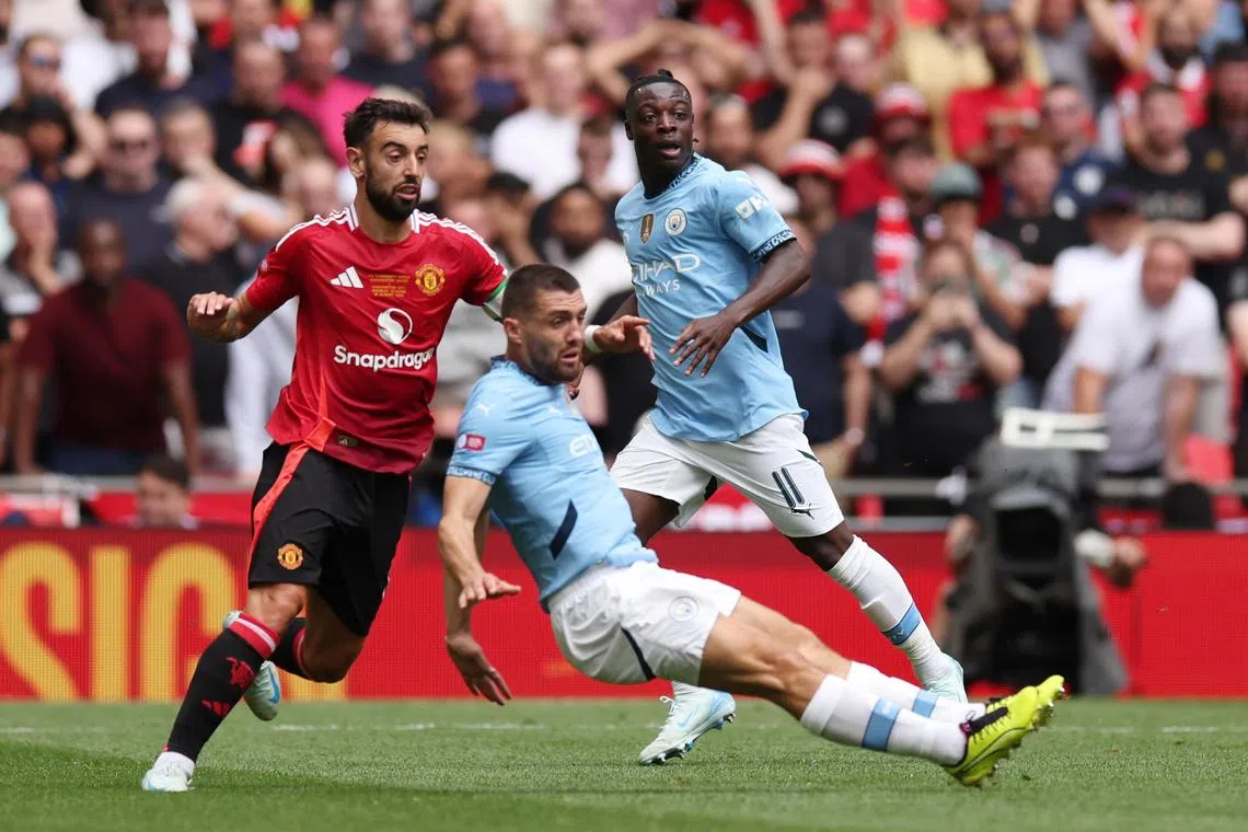 Manchester United's Bruno Fernandes (left) vying for the ball with Manchester City’s Mateo Kovacic during the Community Shield at Wembley on Aug 10. City won on penalties after the match ended 1-1.