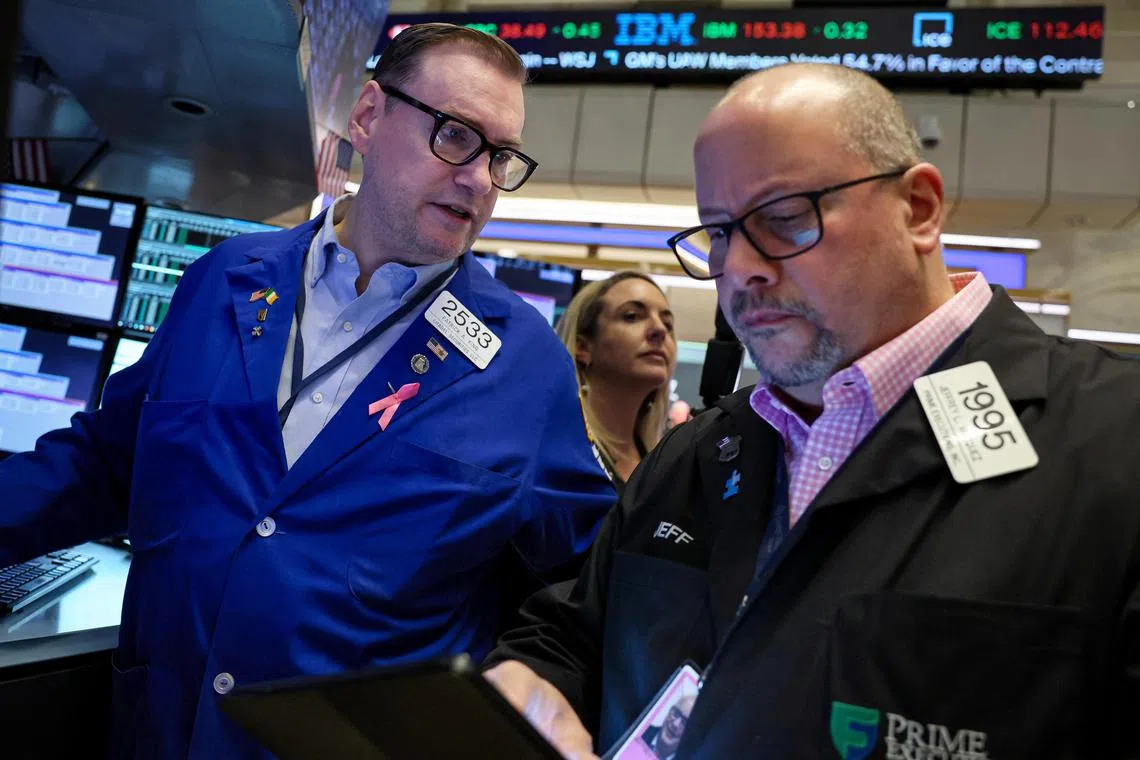 Traders work on the floor at the New York Stock Exchange, in New York City.