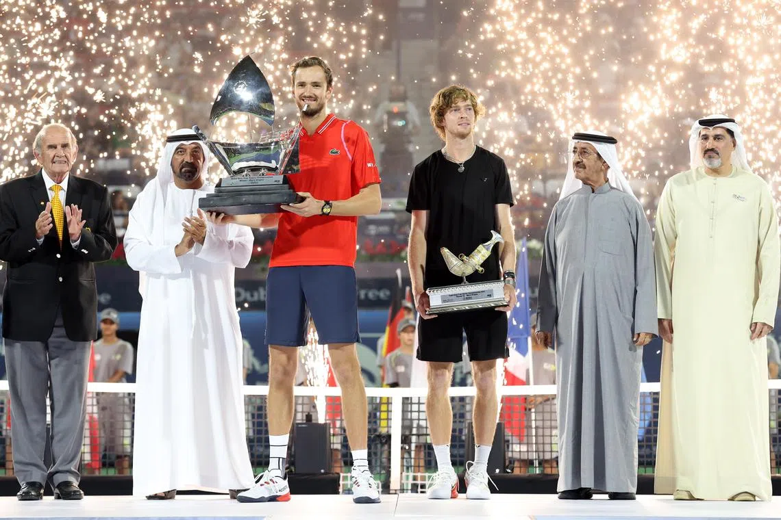 Daniil Medvedev (left) and Andrey Rublev pose with their trophies after the final at the Dubai Duty Free Tennis Championships.