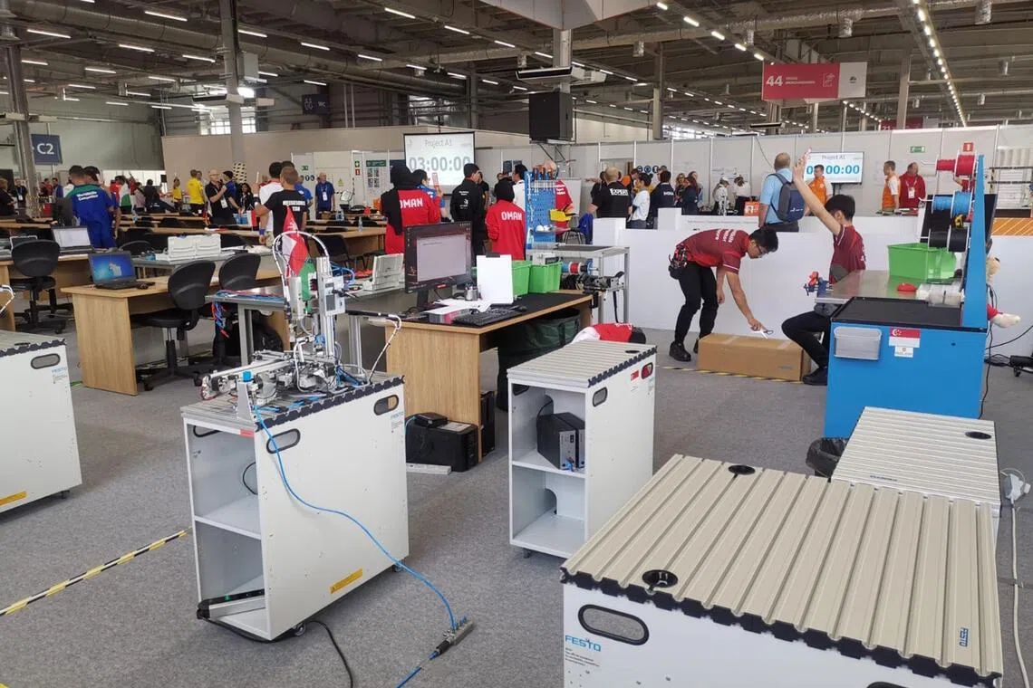 Former mechatronics competitor Arthur Liew (holding scissors) moments before he cut his finger at WorldSkills Kazan in 2019.