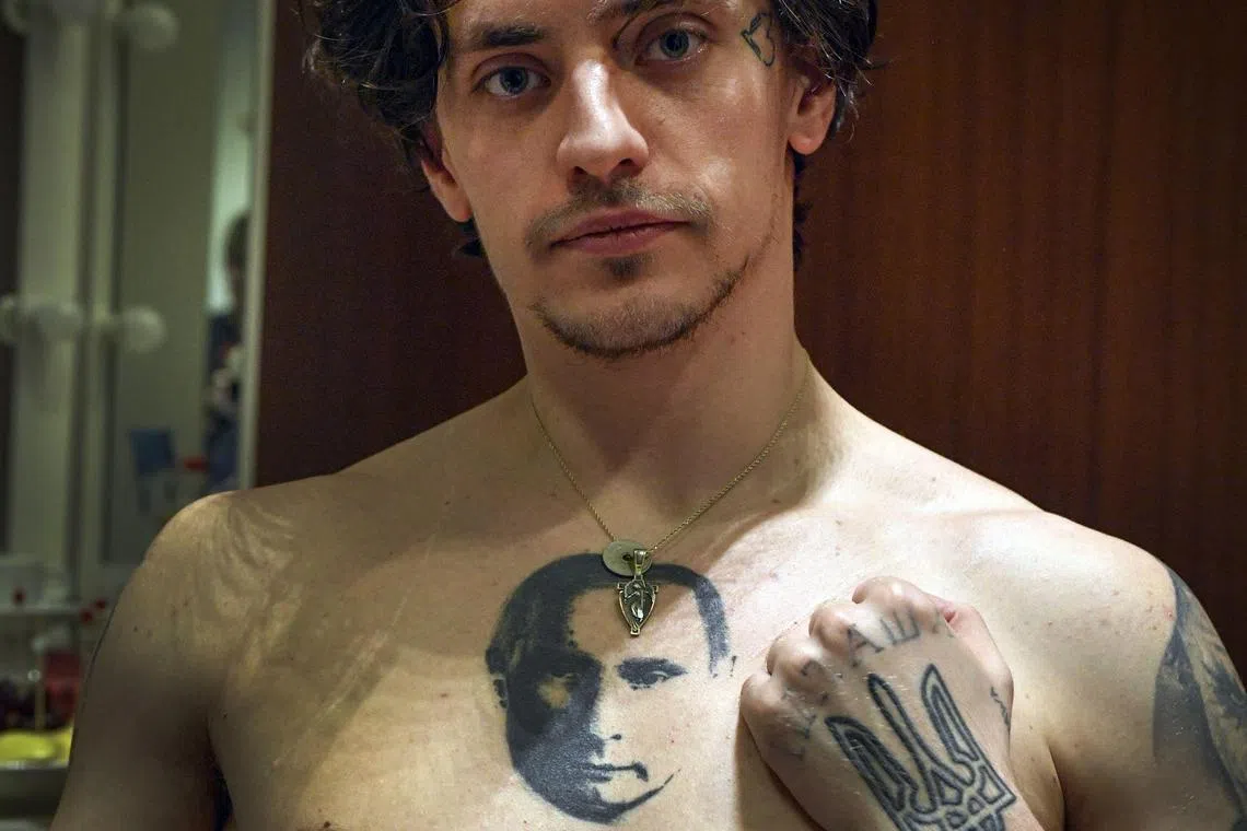 Ukrainian-born ballet dancer Sergei Polunin showing his tattoos, with one depicting Russian President Vladimir Putin and another the Ukrainian national trident symbol, in 2019.