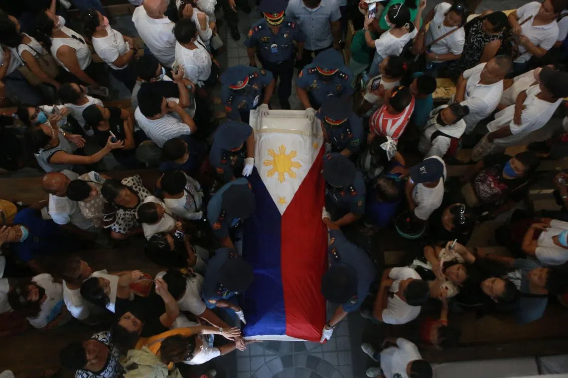Policemen carry the coffin of the Mr Roel Degamo, a Philippine governor killed in one of the Philippines' deadliest political attacks in years.