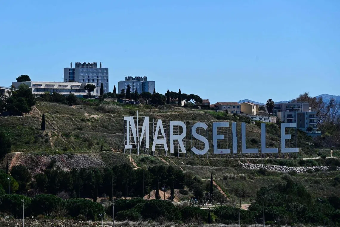 A photograph taken on March 27, 2023 shows a sign reading "Marseille" installed in the northern neighborhood of Marseille, southern France. - Supporting the siblings of young drug dealers, investing in social networks or legalising cannabis: six concrete proposals from experts, sometimes inspired by foreign countries, to combat drug trafficking in France, which is now spreading to rural areas. (Photo by CHRISTOPHE SIMON / AFP)