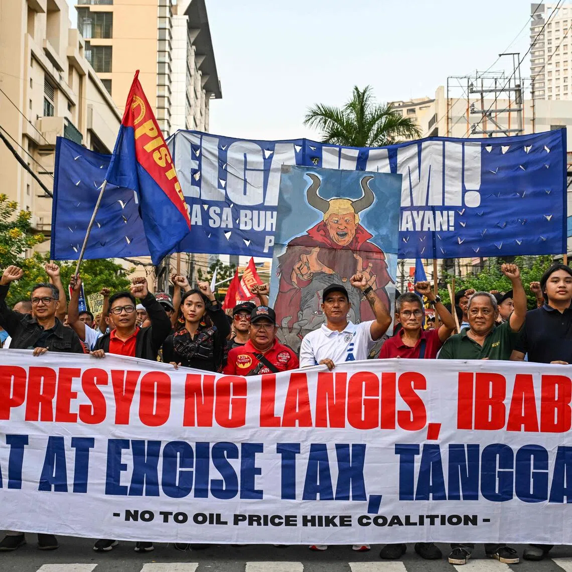 Protesters march along a Manila street to press for a rollback in oil prices and removal of value-added and excise taxes.