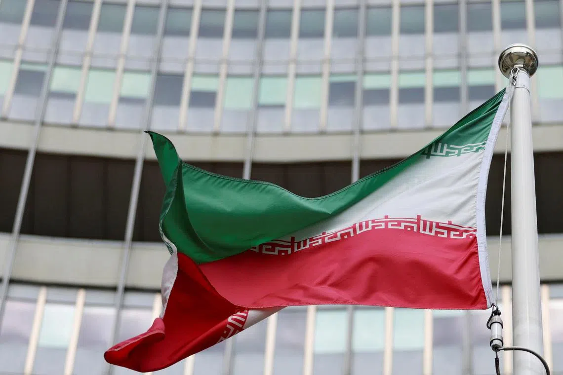 FILE PHOTO: The Iranian flag flutters outside the IAEA headquarters after the first day of the agency's quarterly Board of Governors meeting at the IAEA headquarters in Vienna, Austria, June 9, 2025. REUTERS/Lisa Leutner/File Photo