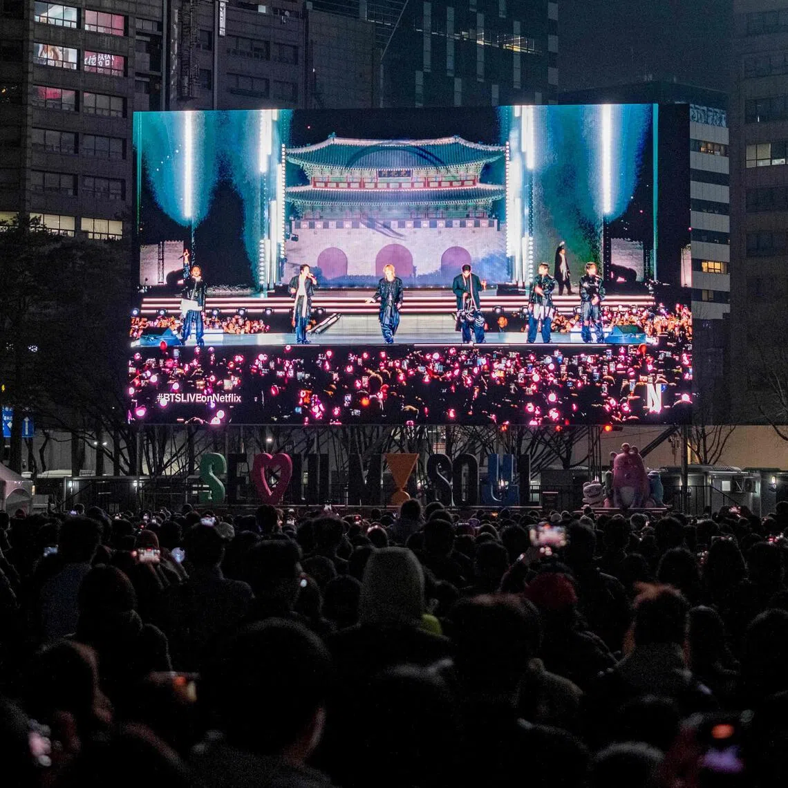 Fans watch the comeback concert of K-pop boy group BTS on a screen at the venue in Seoul on March 21.