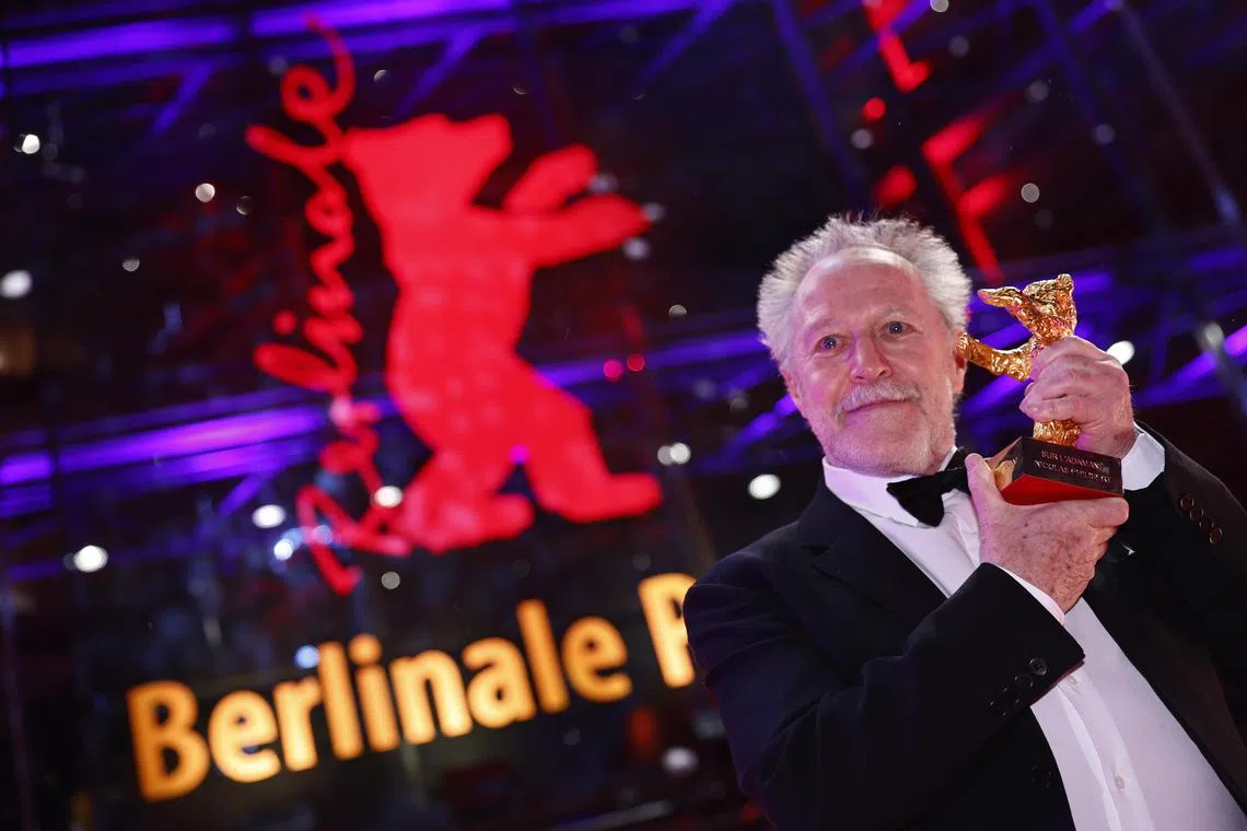 French director Nicolas Philibert poses with his Golden Bear at the 73rd Berlin International Film Festival in Germany.