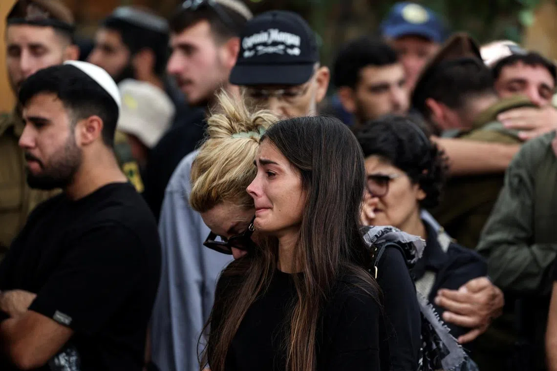 People mourn Mr Adi Zur, an Israeli soldier killed when Hamas gumen stormed border towns in southern Israel.