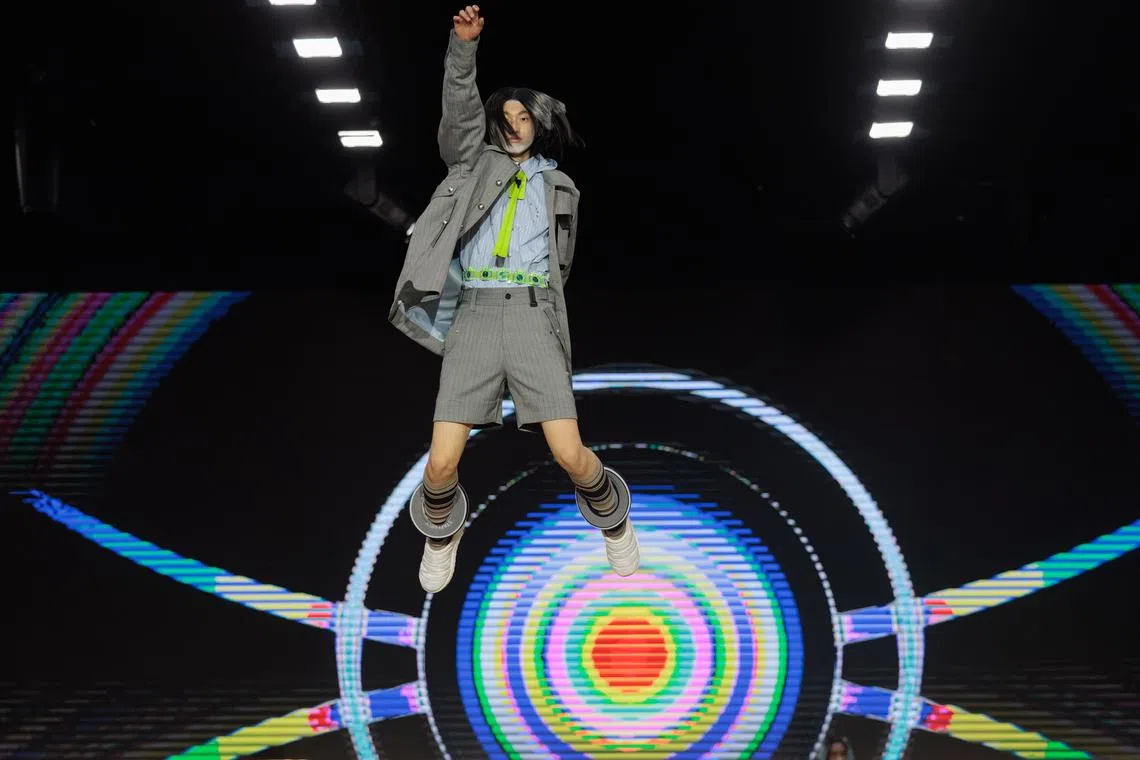 A model jumps on the trampoline while presenting a creation at the Staffonly runway presentation during the Shanghai Fashion Week Autumn/Winter 2023 in Shanghai, China, March 30.