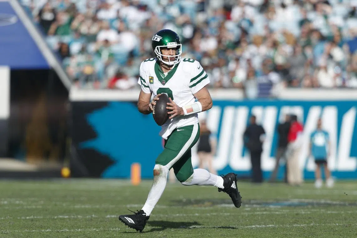 Dec 15, 2024; Jacksonville, Florida, USA; New York Jets quarterback Aaron Rodgers (8) looks for a pass against the Jacksonville Jaguars during the fourth quarter at EverBank Stadium. Morgan Tencza-Imagn Images/File Photo
