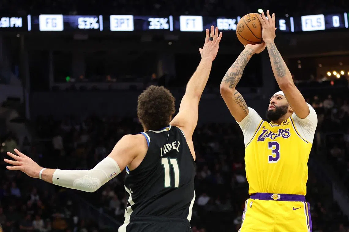 Anthony Davis of the Los Angeles Lakers shoots over Brook Lopez of the Milwaukee Bucks during the second half at Fiserv Forum.