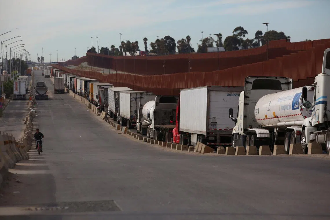 FILE PHOTO: Trailer trucks queue to cross into the United States at the Otay Mesa Port of Entry, in Tijuana, Mexico, November 27, 2024. REUTERS/Jorge Duenes/File Photo
