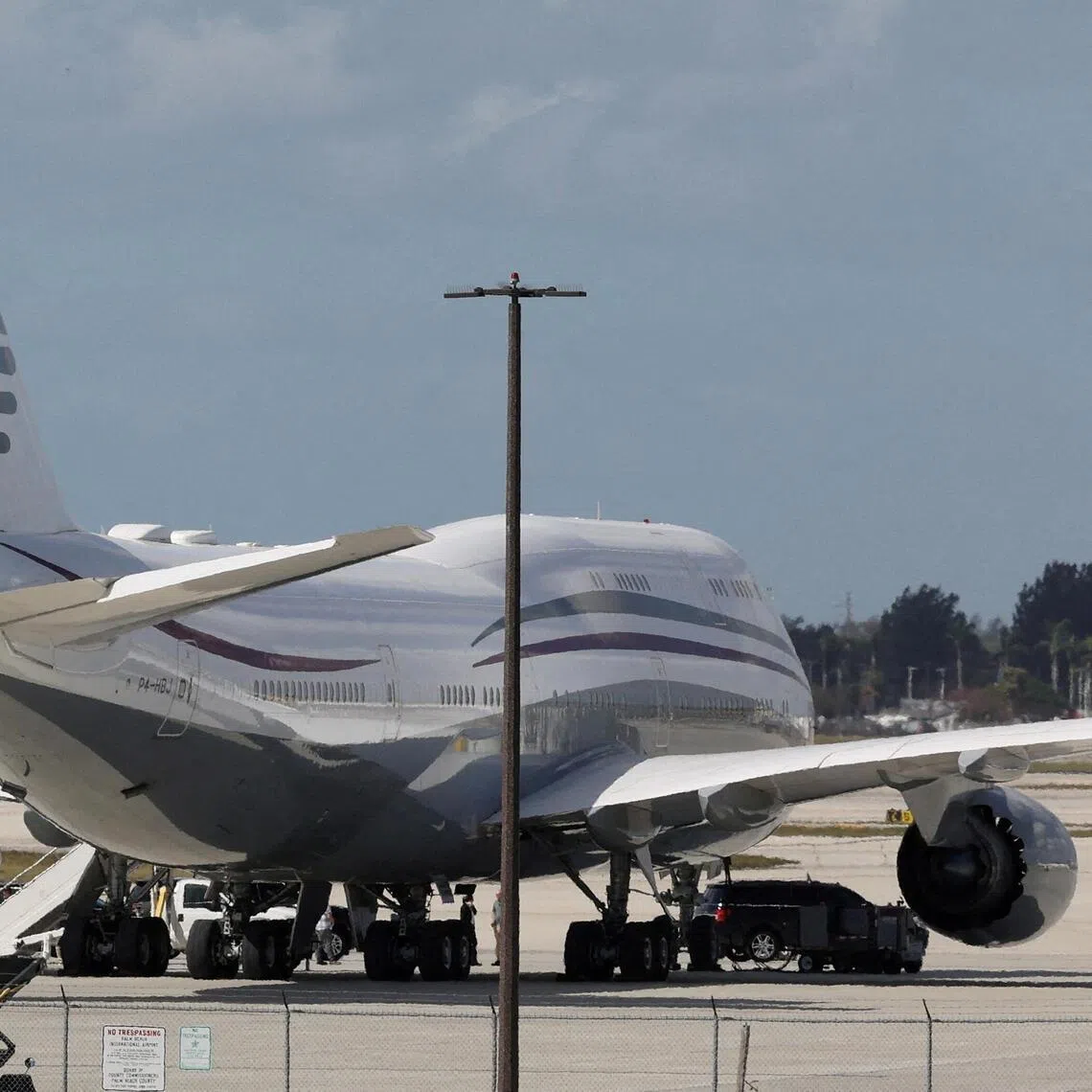 FILE PHOTO: The motorcade of U.S. President Donald Trump is parked next to a 12-year-old Qatari-owned Boeing 747-8 that Trump was touring in West Palm Beach, Florida, U.S., February 15, 2025. REUTERS/Kevin Lamarque/File Photo