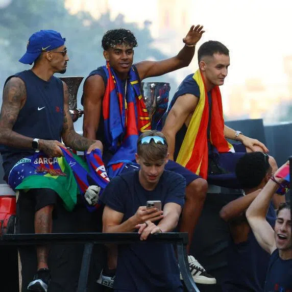 FC Barcelona's Lamine Yamal (centre) during the bus parade on May 11 as they celebrate winning La Liga championship.