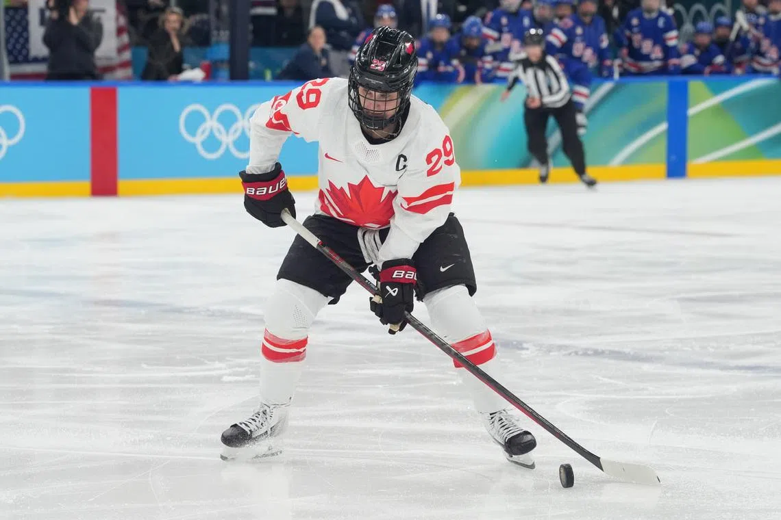 Feb 19, 2026; Milan, Italy; Marie-Philip Poulin (29) of Canada control the puck against the United States in the women's ice hockey gold medal game during the Milano Cortina 2026 Olympic Winter Games at Milano Santagiulia Ice Hockey Arena. Mandatory Credit: Amber Searls-Imagn Images
