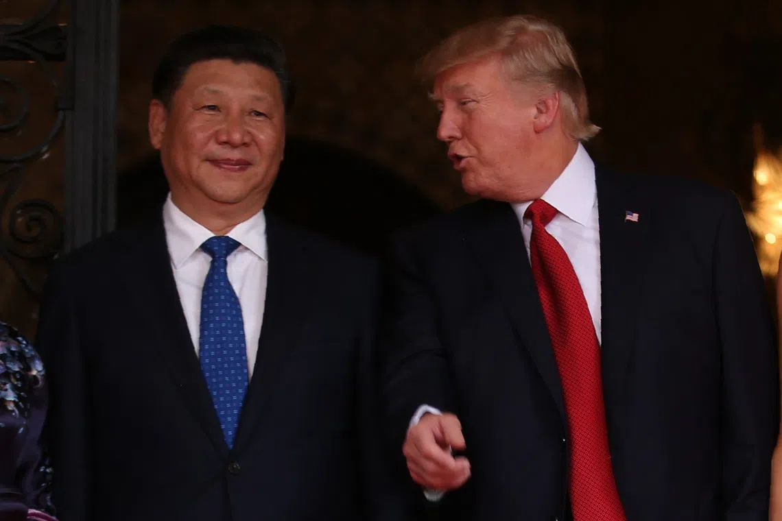 U.S. President Donald Trump talks with Chinese President Xi Jinping as Xi arrives for dinner at the start of their summit at Trump’s Mar-a-Lago estate in West Palm Beach, Florida, U.S. April 6, 2017.    REUTERS/Carlos Barria