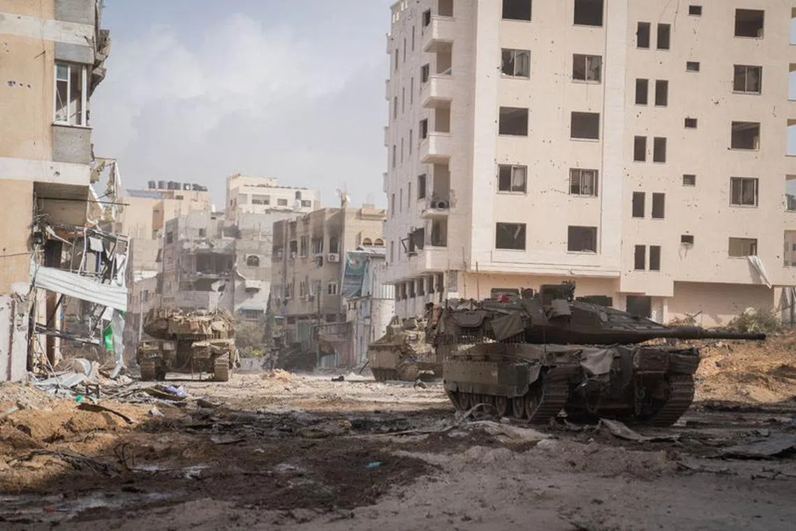 Israeli tanks operate in a location given as Gaza, amid the ongoing ground operation of the Israeli army against the Palestinian Islamist group Hamas, in this handout image released on November 21, 2023. Israel Defense Forces/Handout via REUTERS