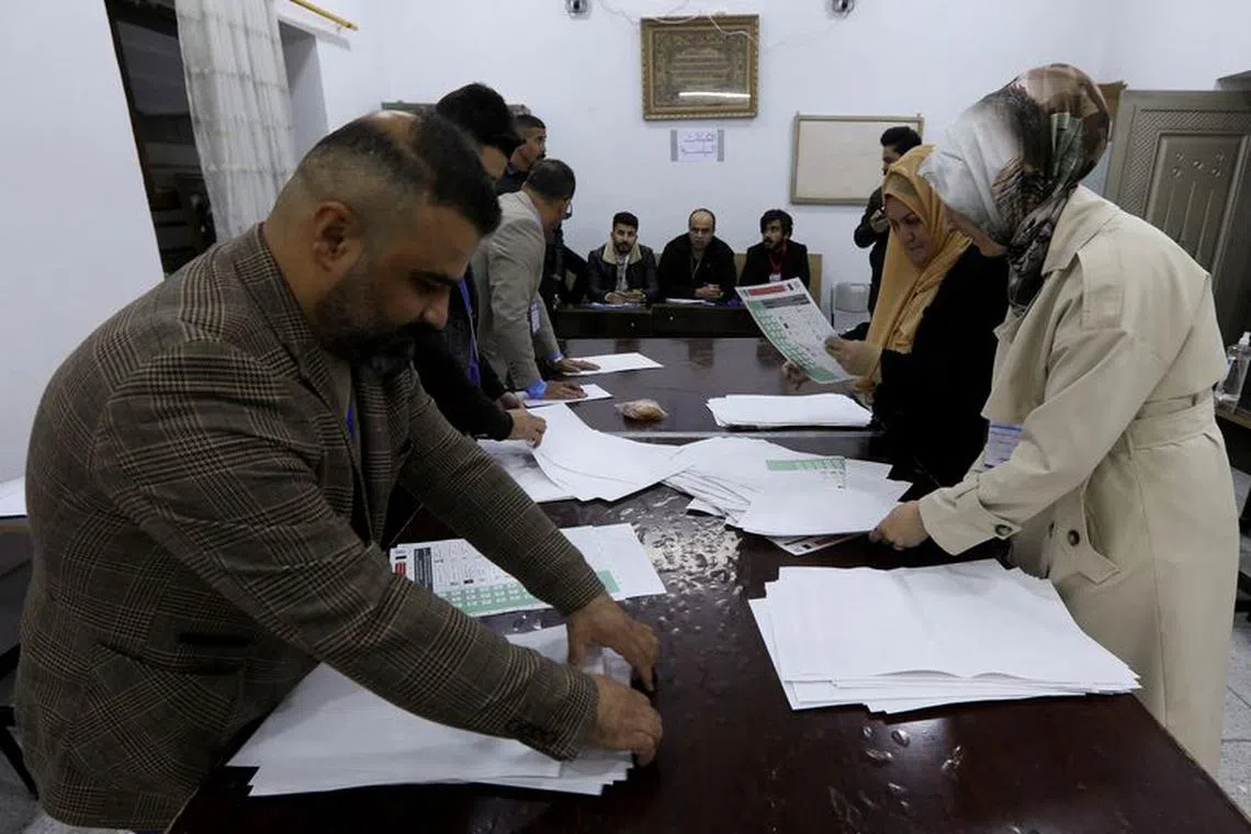 FILE PHOTO: Officials sort ballot papers after the closing of the polling station during Iraq's provincial council elections, in Kirkuk, Iraq December 18, 2023. REUTERS/Ako Rasheed/File Photo