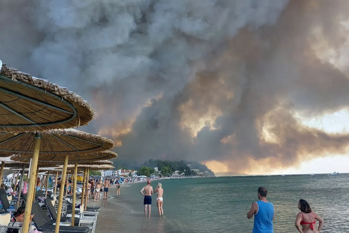 The fire bore down on homes around the popular resorts of Siviri and Fourka on Greece’s Halkidiki peninsula, much of which is covered by highly flammable pine forests.