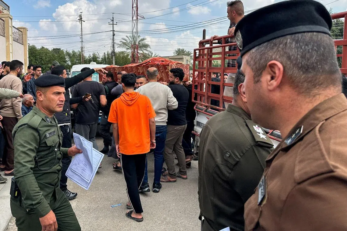 Relatives carry the coffin of an Iraqi soldier killed in an airstrike near an army medical centre in western Anbar, at the forensic medicine department of Ramadi General Hospital, Iraq March 25, 2026. REUTERS/Osama Al-Dulaimi