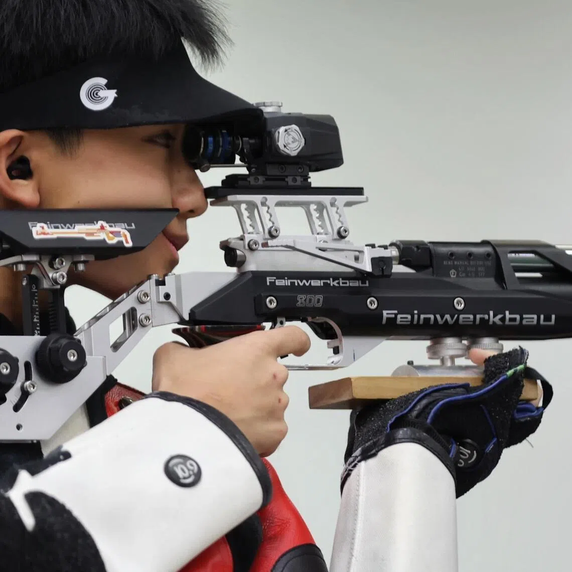 Matthew Cheong from Raffles Institution taking aim with his lucky Koala Bear keychain during the National School Games Men's 10m Air Rifle final held at the Safra Indoor Air Weapon Range on April 10, 2026