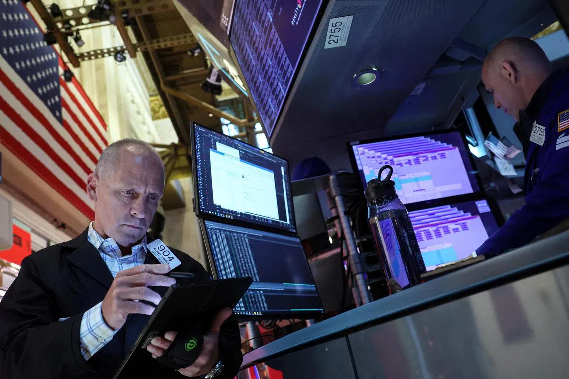 Traders work on the floor of the New York Stock Exchange, in New York City.  