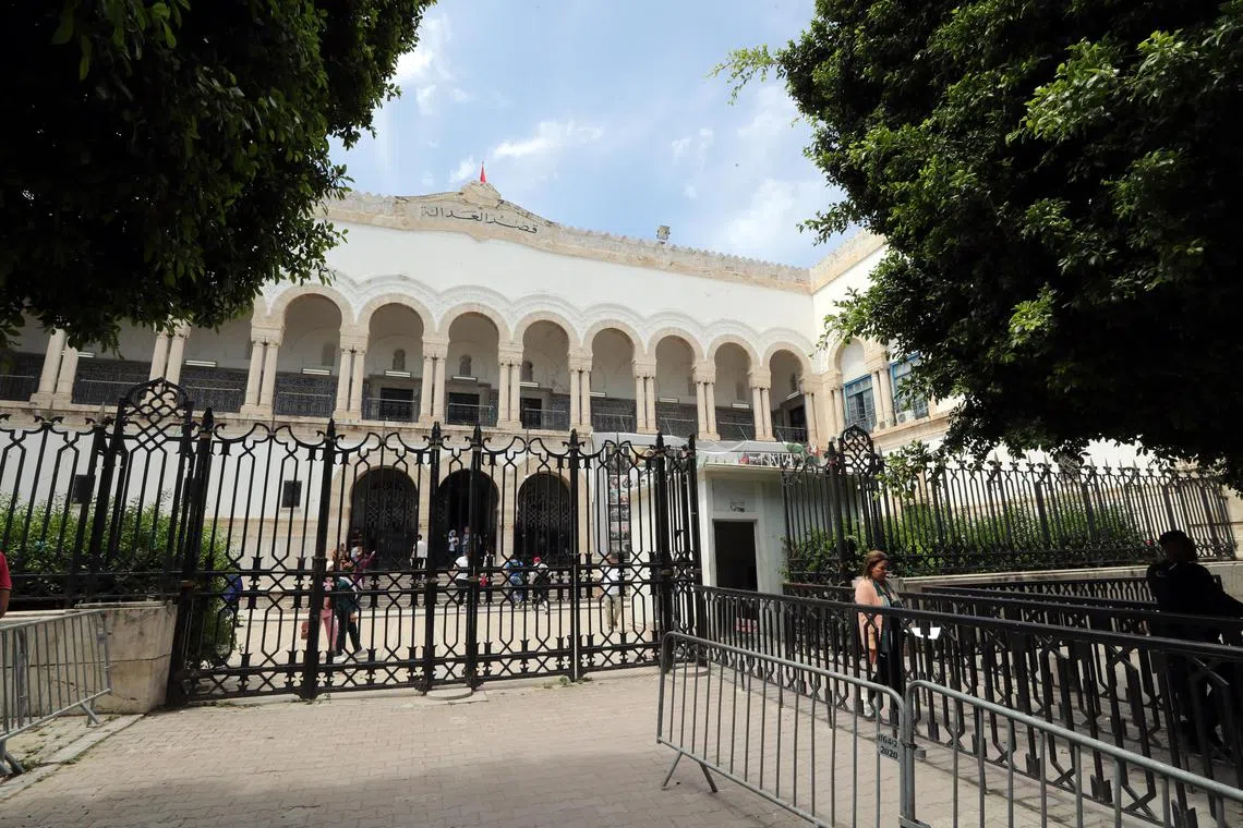 People walk outside the Palace of Justice building in Tunis, Tunisia.