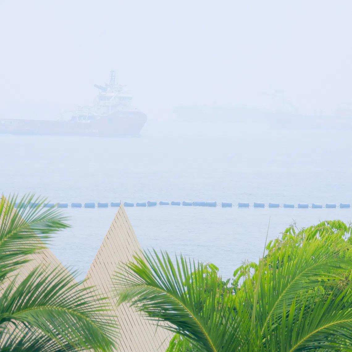 Ships sail in hazy conditions in the waters off Siloso Beach on Oct 14.