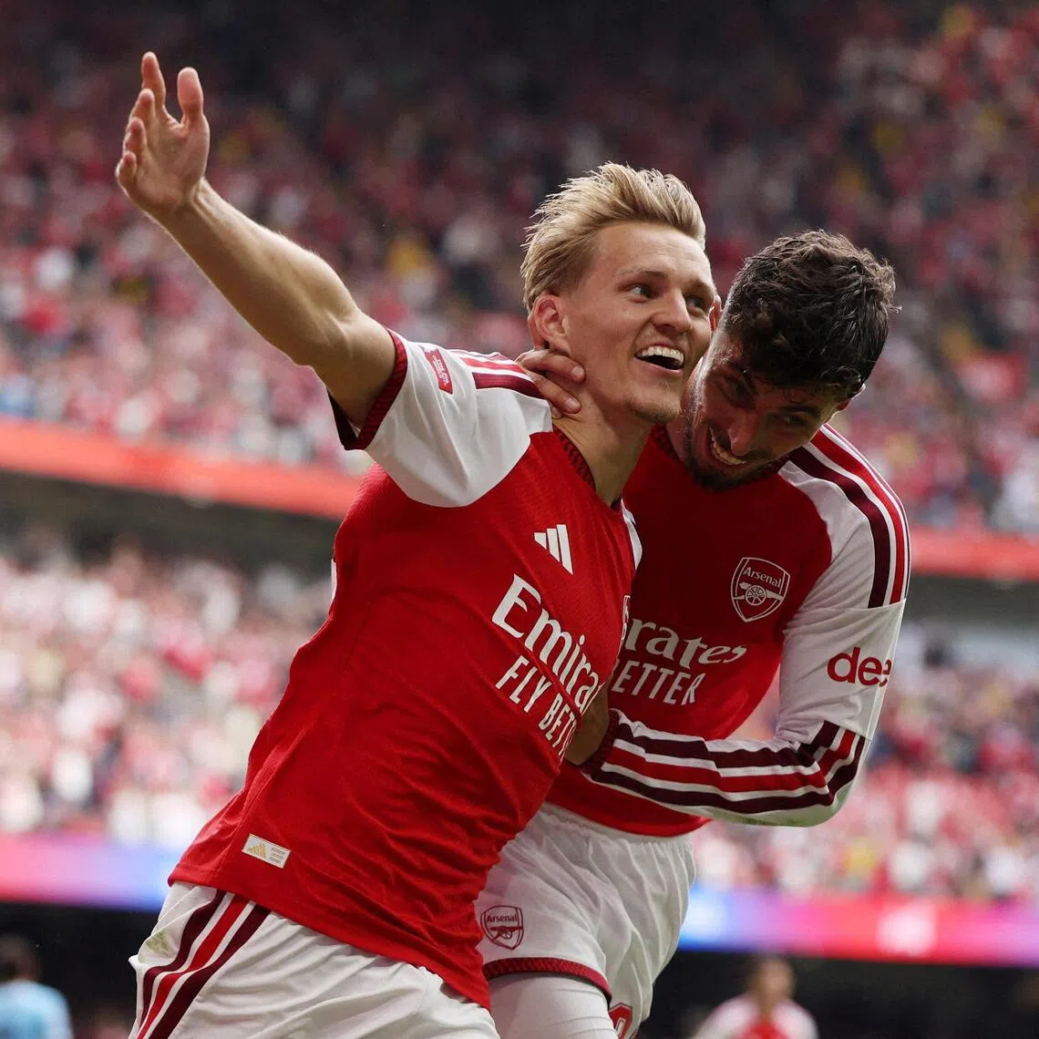 Arsenal’s Martin Odegaard celebrates scoring their third goal with Kai Havertz.