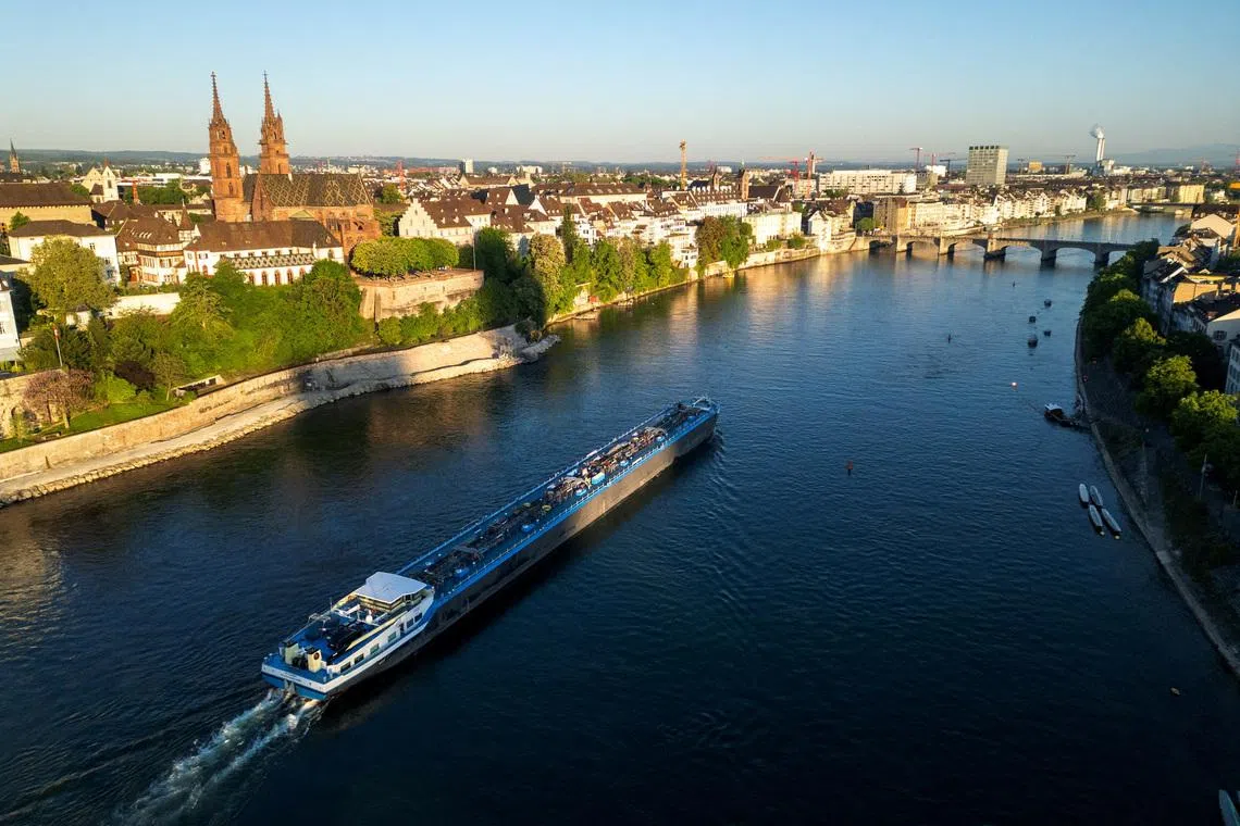 A drone view shows a barge on the Rhine river in front of the Muenster cathedral ahead of the Eurovision Song Contest in Basel, Switzerland, May 1, 2025. REUTERS/Denis Balibouse