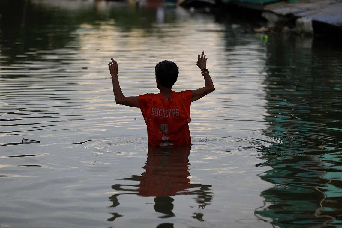 A villager wading through a flooded village after Typhoon Toraji in Tuguegarao city, Cagayan province, Philippines, Nov 13,  2024. Typhoon Usagi, the fourth to barrel the Philippines, threatens to hit land on Nov 14, and will bring more rain to the northern Luzon island after the onslaught of Typhoons Toraji, Trami, and Kong-Rey. 