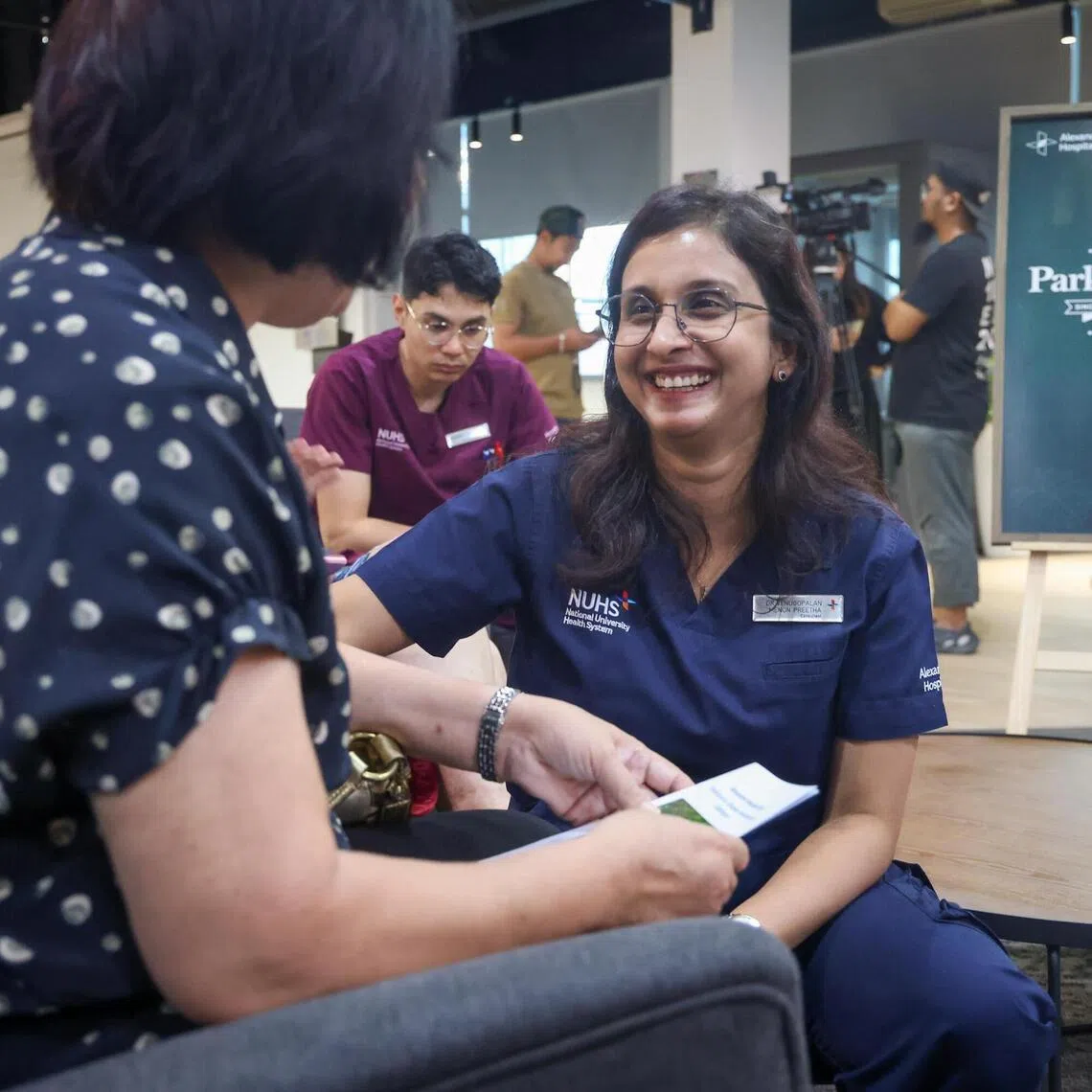 ST20260318_202613600123/jtcafe18/Jason Quah

Dr Venugopalan Menon Preetha, Parkinson's Cafe@AH Lead Consultant, Geriatric Medicine, Alexandra Hospital working with patients at Parkinson's Cafe@AH on March 18, 2026. ST PHOTO: JASON QUAH