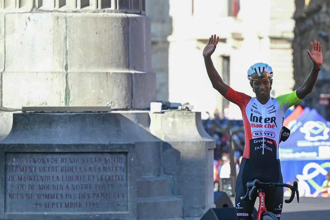 Biniam Girmay waving to spectators during the official teams' presentation ahead of the 2025 Tour de France in July.