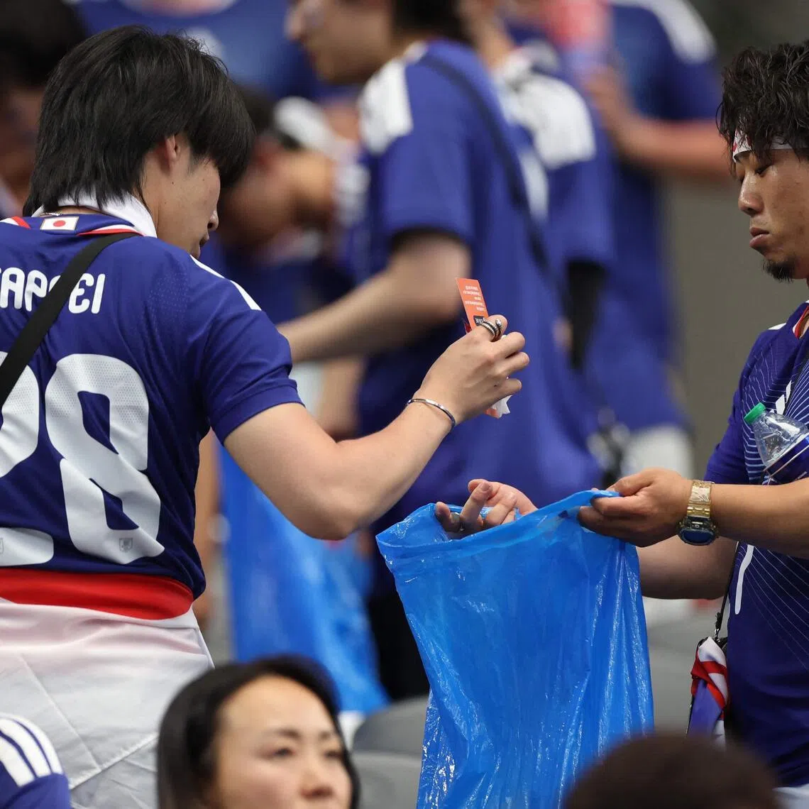 Japan fans clear trash in the stands during the 2026 World Cup on June 14.