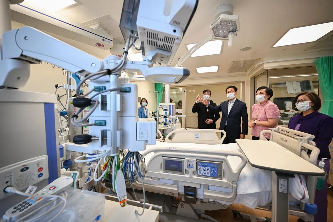 Health Minister Ong Ye Kung, flanked by chief executive James Lam and deputy director of nursing Kathleen Low, touring an upgraded ICU at Mount Alvernia Hospital on April 9.