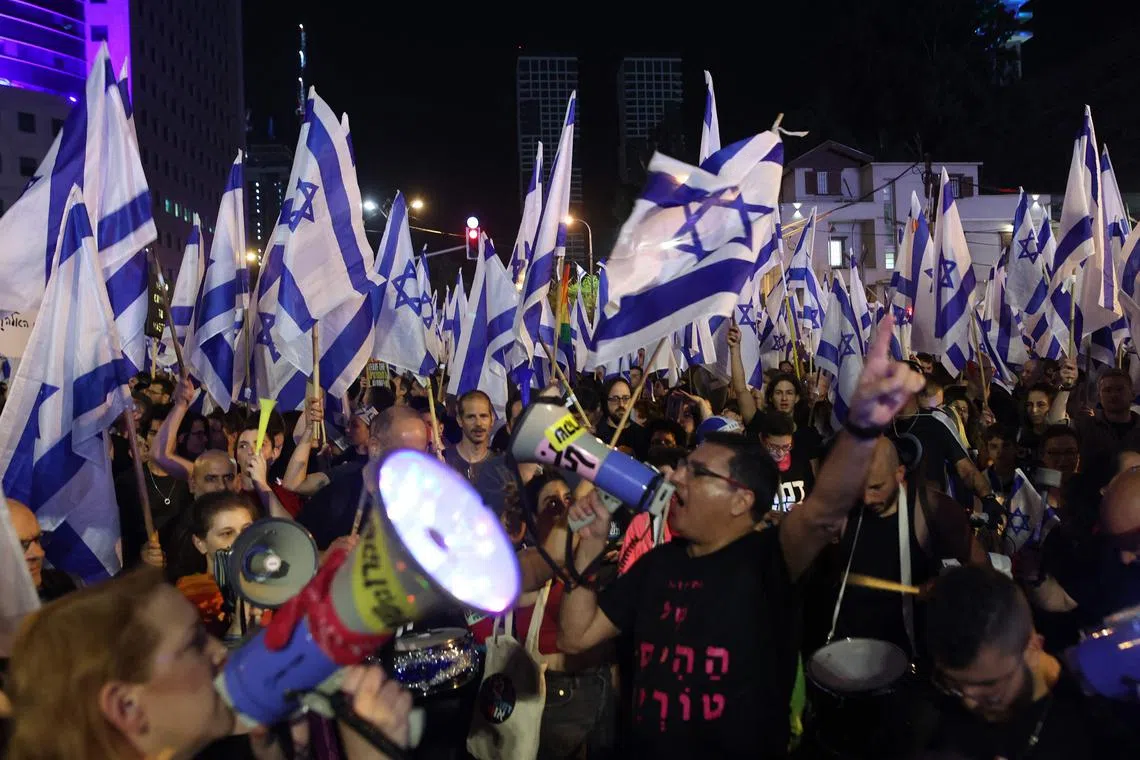 Protesters take part in ongoing demonstrations against the government's judicial reform Bill in Tel Aviv.