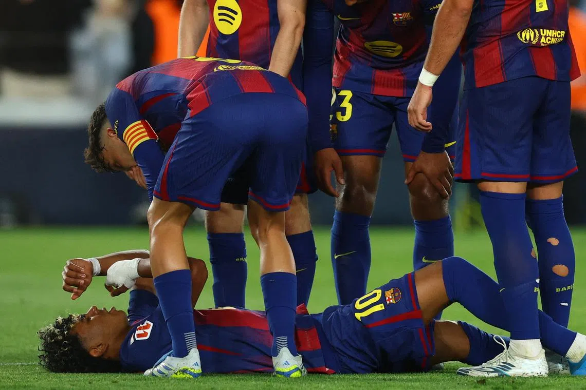 Soccer Football - LaLiga - FC Barcelona v Celta Vigo - Spotify Camp Nou, Barcelona, Spain - April 22, 2026 FC Barcelona's Lamine Yamal reacts after sustaining an injury REUTERS/Albert Gea
