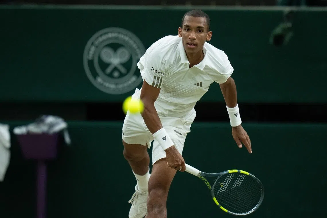 Jul 7, 2026; London, United Kingdom; Felix Auger-Aliassime of Canada serves the ball during his match against Novak Djokovic of Serbia on day nine at All England Lawn Tennis and Croquet Club.  Mandatory Credit: Susan Mullane-Imagn Images