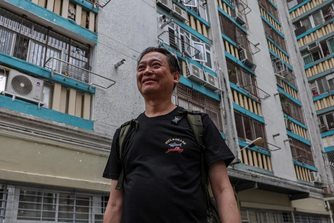 Jason Kong, 65 years-old, walks towards a building at Wang Fuk Court to retrieve personal belongings during his first return visit after a deadly fire last year, in Hong Kong, China, April 23, 2026. REUTERS/Tyrone Siu