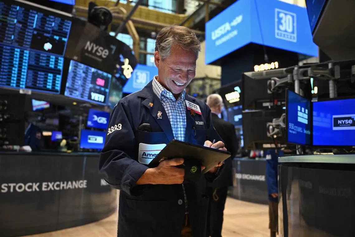 Traders work on the floor of the New York Stock Exchange, during morning trading in New York on Aug 23.