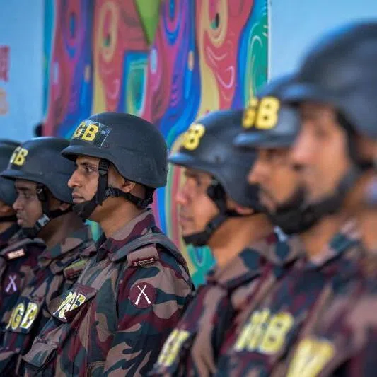 Border Guard Bangladesh personnel standing guard along a road in Dhaka on Nov 16, ahead of the court's verdict in a case against fugitive ex-prime minister Sheikh Hasina.
