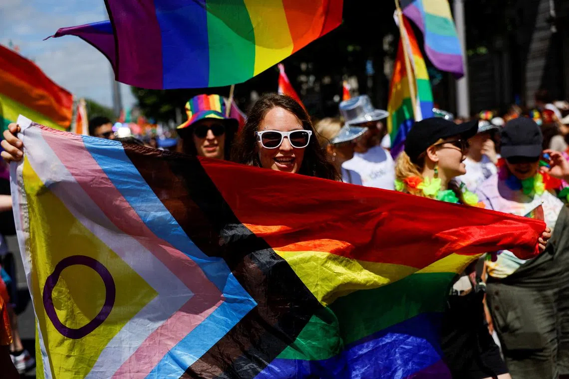 FILE PHOTO: A person holds a flag during the annual Pride parade in Dublin, Ireland, June 24, 2023. REUTERS/Clodagh Kilcoyne/File Photo