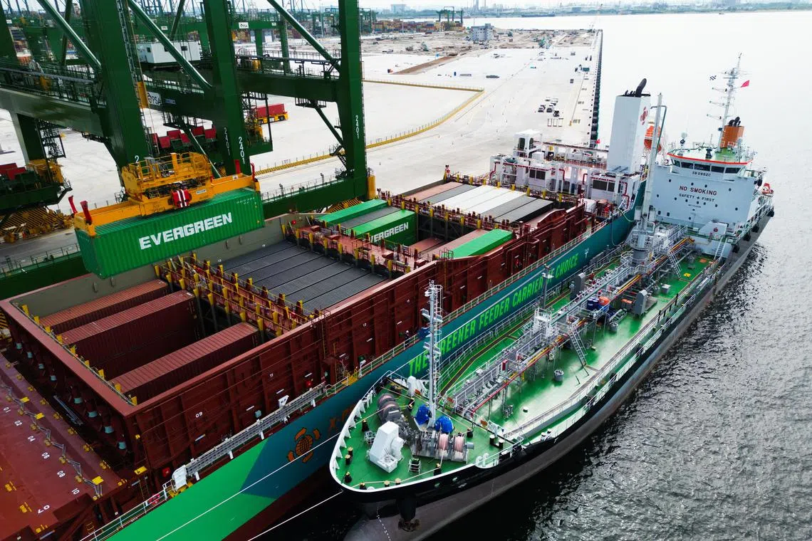 X-Press Feeders' cargo vessel Eco Maestro (middle) simultaneously taking on cargo at Tuas Port and being refuelled with methanol by bunker ship MT Kara  (right). 