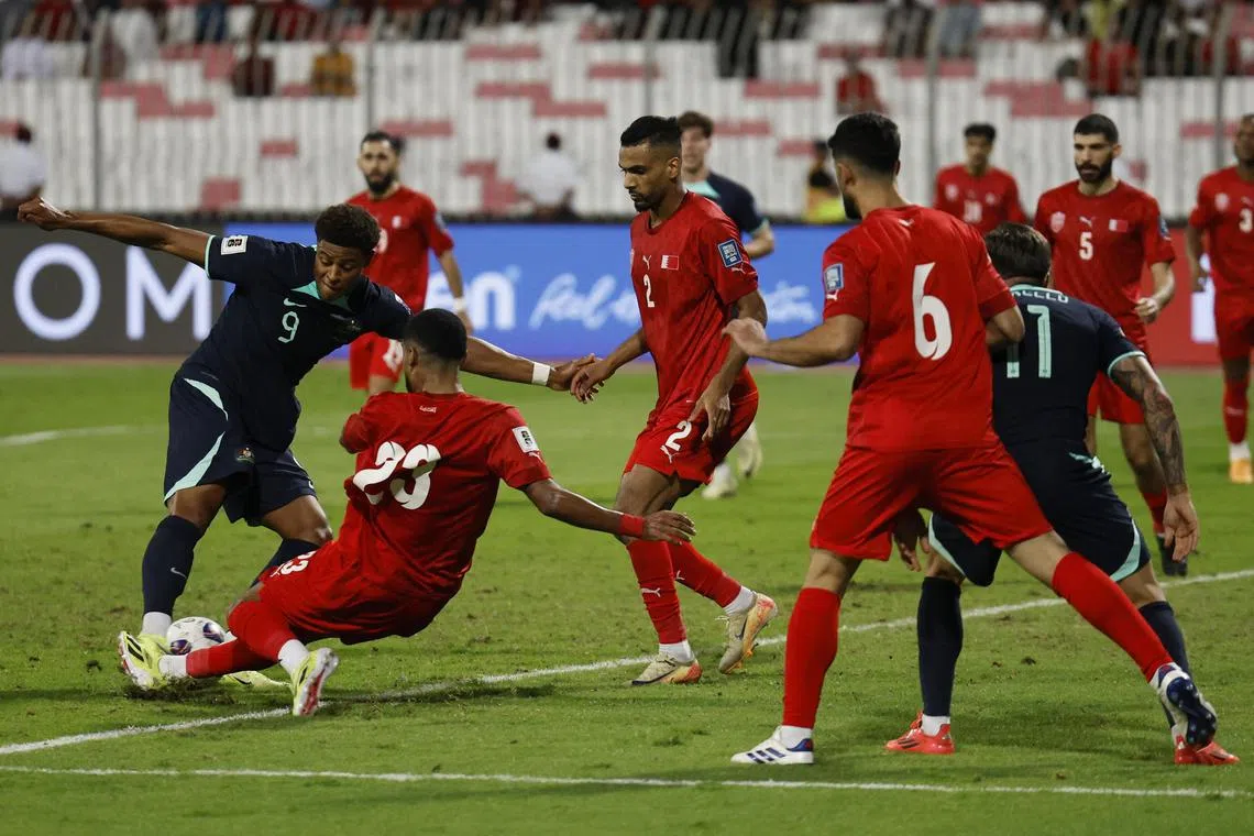 Australia's Kusini Yengi scoring a late equaliser in a 2-2 Asian World Cup qualifying Group C stalemate against Bahrain at the Bahrain National Stadium in Riffa on Nov 19.