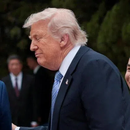US President Donald Trump (right) and Chinese President Xi Jinping at their meeting in Beijing on May 15.