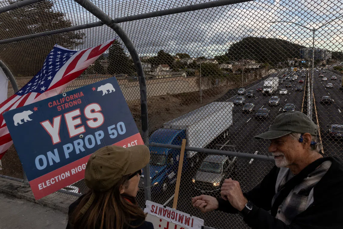 Supporters of Proposition 50 gather over a pedestrian overpass during California's special election on Proposition 50, a measure that would temporarily redraw congressional districts, in Richmond, California, U.S., November 4, 2025. REUTERS/Carlos Barria