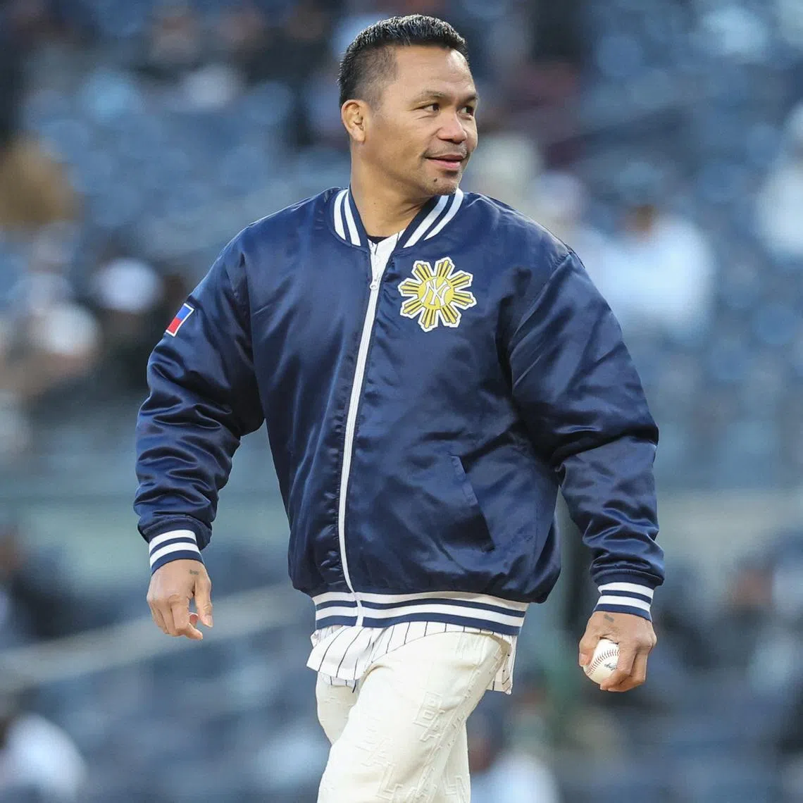 Apr 7, 2026; Bronx, New York, USA;  Professional boxer Manny Pacquiao prepares to throw out the first pitch prior to the game between the Athletics and the New York Yankees at Yankee Stadium. Wendell Cruz-Imagn Images